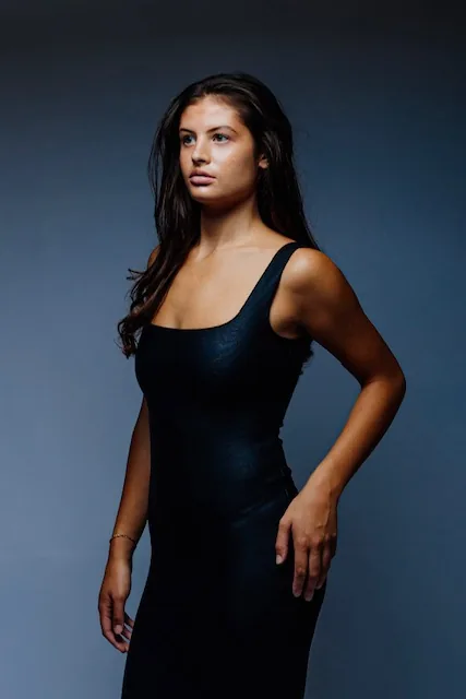 Three-quarter angle portrait against dark grey background